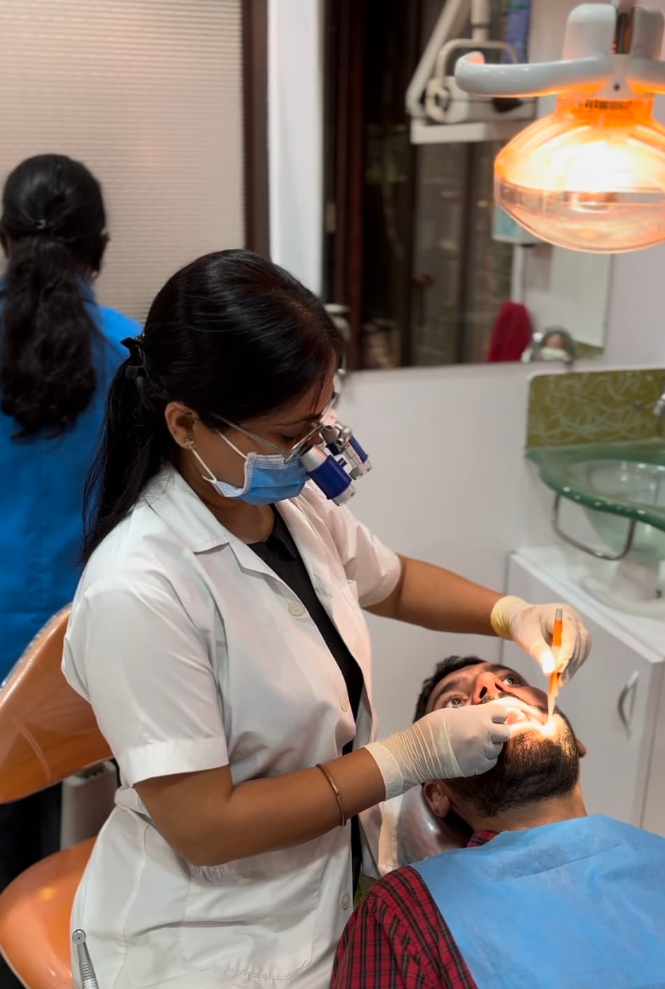 Dr. Swati Bharti providing root canal treatment using magnification loupes