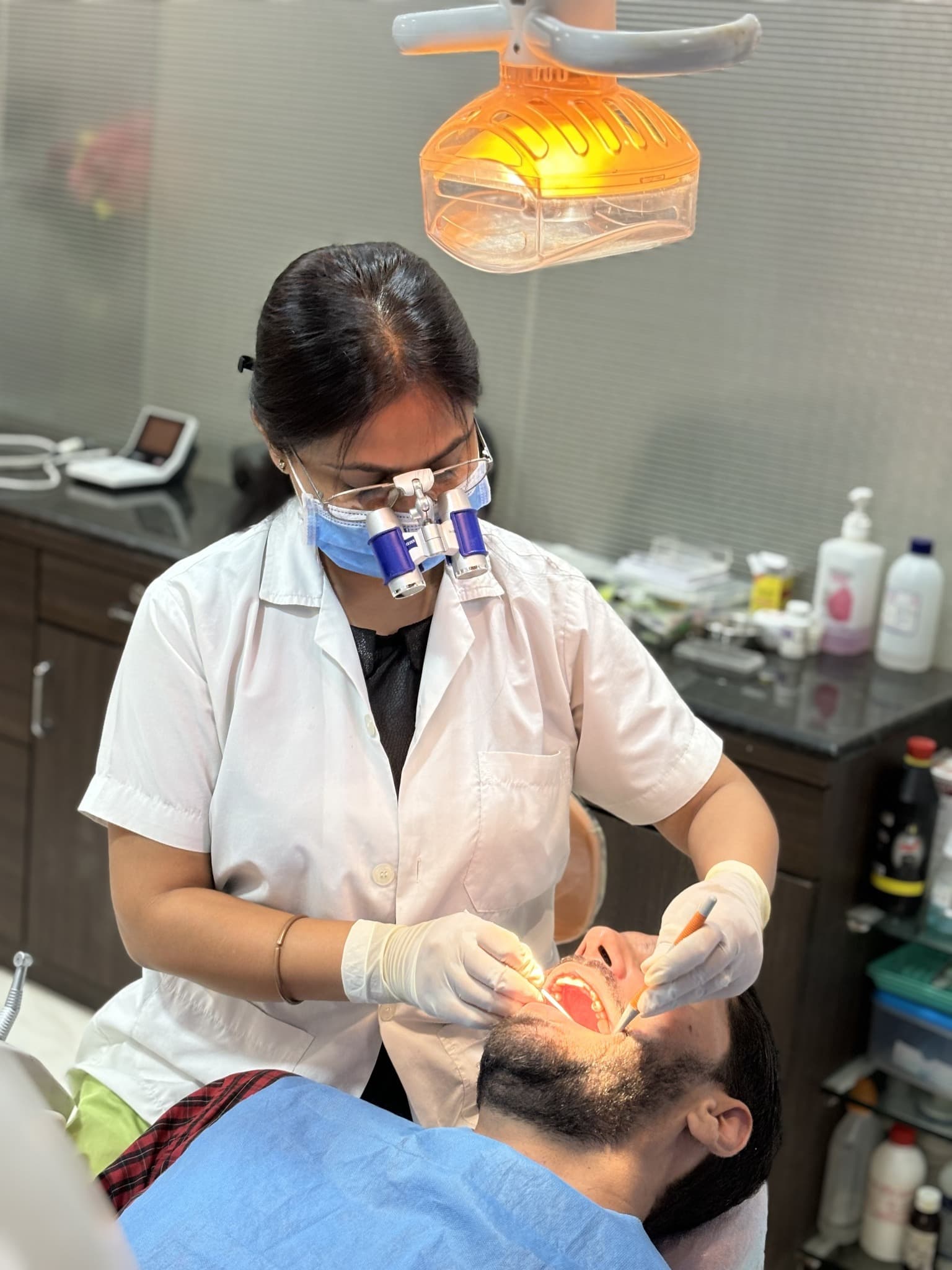 Dr. Swati Bharti providing root canal treatment using magnification loupes